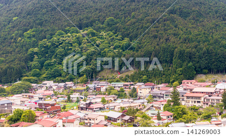 Houses nestled in the mountains and rural townscapes, surrounded by lush, deep forests. Houses nestled in the mountains and rural townscapes, surrounded by lush, deep forests. 141269003