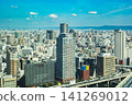 Osaka's skyscrapers and urban panorama spread out under a blue sky. 141269012