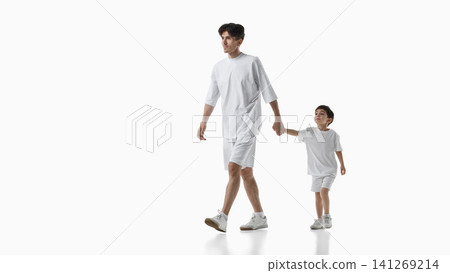 Father holding young son hand while walking together on white background. Father holding young son hand while walking together on white background. 141269214