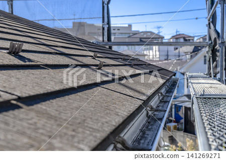 Before renovation: deteriorated slate roof and dirty rain gutters. Before renovation: deteriorated slate roof and dirty rain gutters. 141269271