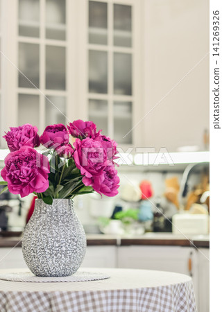 Pink peony bouquet in a kitchen interior Pink peony bouquet in a kitchen interior 141269326