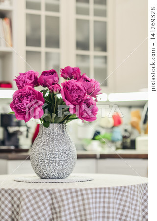 Pink peony bouquet in a kitchen interior Pink peony bouquet in a kitchen interior 141269328