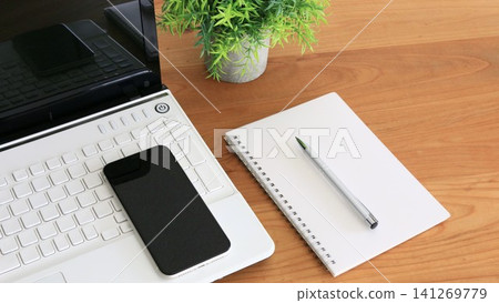 A minimalist business desk with space for a notebook, smartphone, and copy machine. A minimalist business desk with space for a notebook, smartphone, and copy machine. 141269779