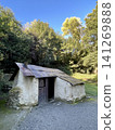 The historic white stucco huts of Arrowtown stand out against the backdrop of beautiful yellow foliage and blue sky. 141269888