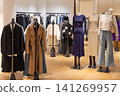Clothing store interior with mannequins and apparel 141269957