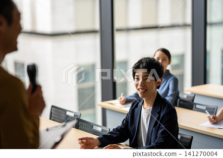 A young male student listening to a lecture 141270004
