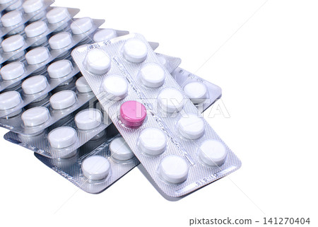 One red pill and many white ones in blister packs 141270404