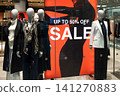 Clothing store mannequins with sale sign 141270883