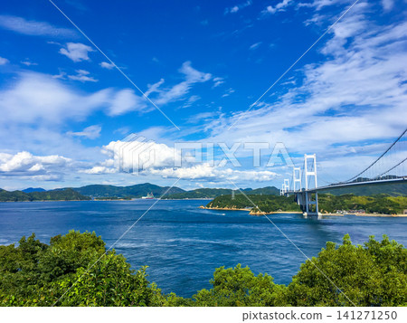 A view overlooking the blue sky, the sea, and the Kurushima Kaikyo Bridge. A view overlooking the blue sky, the sea, and the Kurushima Kaikyo Bridge. 141271250