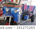 Brightly colored tuk tuk taxi with striped seating ready for passengers Brightly colored tuk tuk taxi with striped seating ready for passengers 141271265
