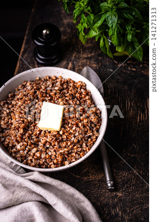 Buckwheat porridge with butter in a white bowl Buckwheat porridge with butter in a white bowl 141271313