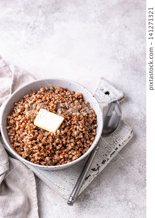 Buckwheat porridge with butter in a white bowl Buckwheat porridge with butter in a white bowl 141271321
