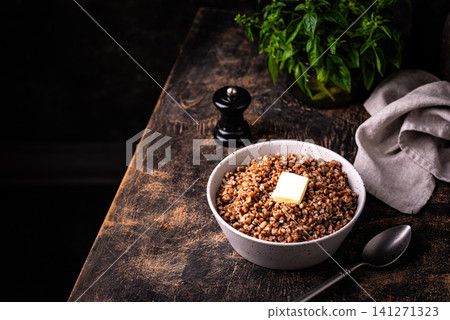 Buckwheat porridge with butter in a white bowl Buckwheat porridge with butter in a white bowl 141271323