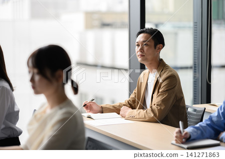 A man listening to a lecture A man listening to a lecture 141271863