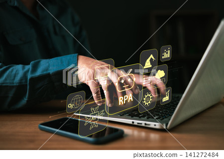 Businessman using laptop with RPA Robotic Process Automation concept on virtual screen. AI technology manages data for automated workflow, industrial manufacturing, and digital business efficiency. 141272484
