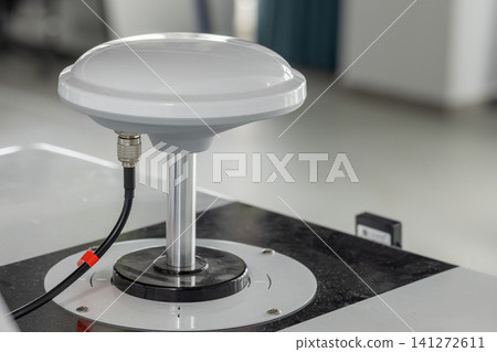 White dome GPS antenna mounted on a metal pedestal White dome GPS antenna mounted on a metal pedestal 141272611