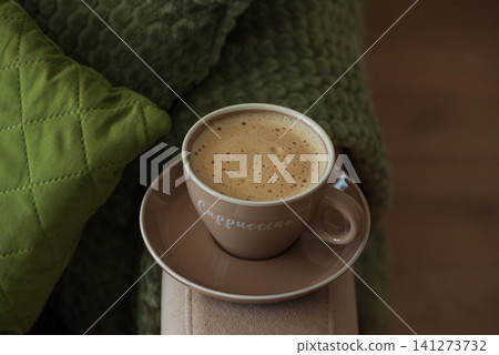 Cappuccino cup creating a cozy morning atmosphere 141273732