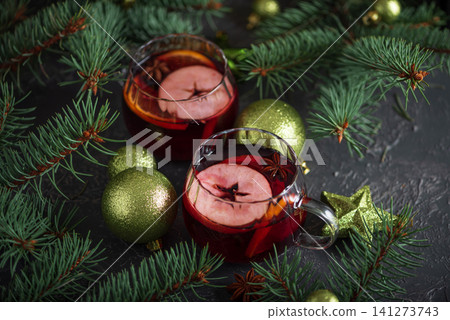 Mulled wine serving with Christmas spices and evergreen branches Mulled wine serving with Christmas spices and evergreen branches 141273743