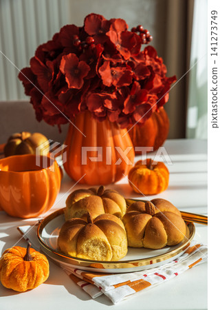 Pumpkin spice buns with autumn decorations and flowers Pumpkin spice buns with autumn decorations and flowers 141273749
