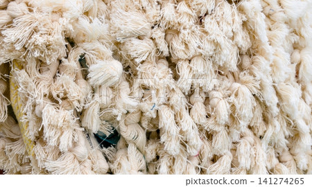 Bohemian style macrame cotton tassels and fringes texture background. Bohemian style macrame cotton tassels and fringes texture background. 141274265