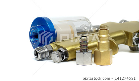 Close-up of air compressor accessories including a filter and various fittings Close-up of air compressor accessories including a filter and various fittings 141274551