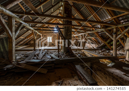 Derelict attic room showing wooden beams and roof structure Derelict attic room showing wooden beams and roof structure 141274585