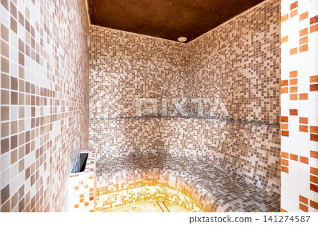 Modern steam room interior with mosaic tiles for wellness Modern steam room interior with mosaic tiles for wellness 141274587