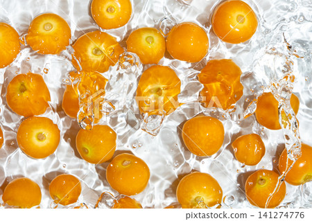 Fresh physalis berries in water splash for refreshing food concept Fresh physalis berries in water splash for refreshing food concept 141274776