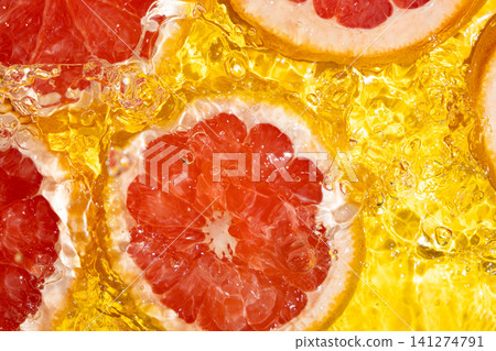 Refreshing background with organic grapefruit in swirling clean water Refreshing background with organic grapefruit in swirling clean water 141274791
