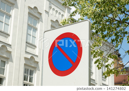 No parking road sign on white background with european historical architecture in blur No parking road sign on white background with european historical architecture in blur 141274802