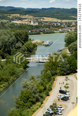 Scenic landscape of the Danube river with a cruise ship and green hills in Melk, Austria Scenic landscape of the Danube river with a cruise ship and green hills in Melk, Austria 141274818