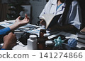 Two asian women doctors discuss meeting doctor's office medical clinic looking x-ray film consulting patient disease. Asian medical lab young women talking together discussing healthcare teamwork 141274866