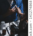 Doctor use stethoscope, checking up heart beat, auscultation in doctor office at hospital. Patient worker has to get medical checkup every year for her health or 141274868