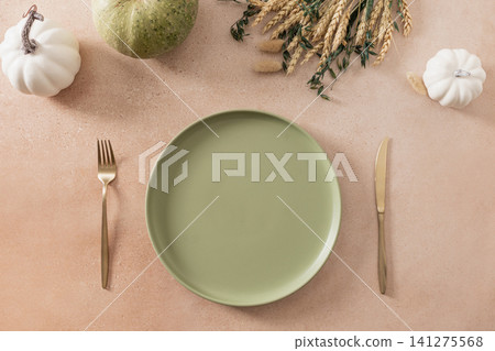 Autumn Thanksgiving table setting with pumpkins and green plate Autumn Thanksgiving table setting with pumpkins and green plate 141275568