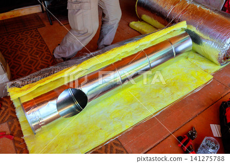 Work on installing ductwork in building with insulation metal tubes laid Work on installing ductwork in building with insulation metal tubes laid 141275788
