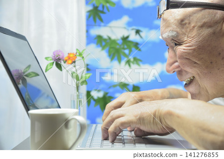 Close-up of a laptop and an old man's face Close-up of a laptop and an old man's face 141276855