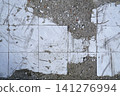 Floor surface with broken white tiles and concrete 141276994