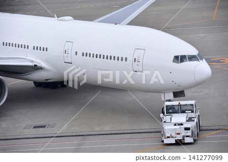 A Boeing 777 being pushed back A Boeing 777 being pushed back 141277099