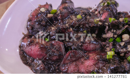 Traditional Southern Thai Stir Fried Squid in Rich Black Ink Sauce Traditional Southern Thai Stir Fried Squid in Rich Black Ink Sauce 141277781