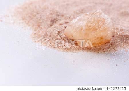 Pink rock salt crystals and fine granular Himalayan rock salt and copy space Pink rock salt crystals and fine granular Himalayan rock salt and copy space 141278415