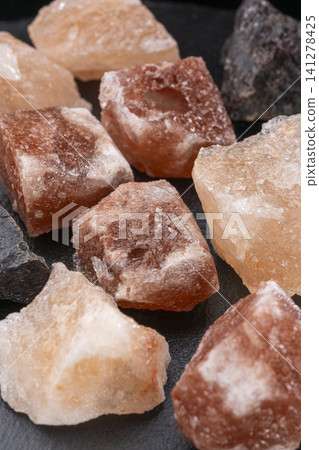 Cooking rock salt and mineral-rich crystals placed against a black background. Cooking rock salt and mineral-rich crystals placed against a black background. 141278425