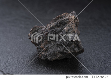 Natural crystals of black rock salt placed against a black background. Natural crystals of black rock salt placed against a black background. 141278426