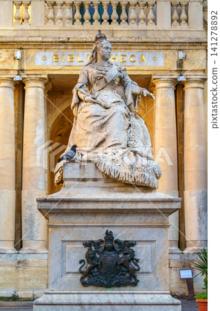 VALLETTA, MALTA - NOVEMBER 12, 2018 - The statue of Queen Victoria in front of the Bibliotheca, in Republic Square at the capital city VALLETTA, MALTA - NOVEMBER 12, 2018 - The statue of Queen Victoria in front of the Bibliotheca, in Republic Square at the capital city 141278892