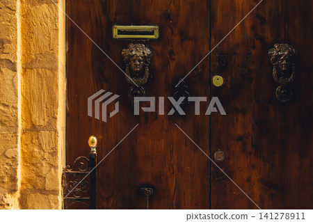 Old vintage weathered wooden door of Malta Old vintage weathered wooden door of Malta 141278911