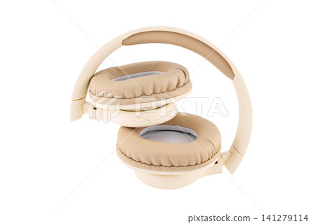 beige wireless headphones in semi folded view on a white background beige wireless headphones in semi folded view on a white background 141279114