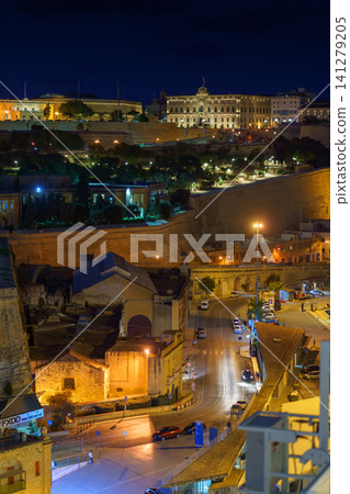 VALLETTA, MALTA - NOVEMBER 12, 2018 - Panoramic night view of a coast line and the downtown of the city with different landmarks VALLETTA, MALTA - NOVEMBER 12, 2018 - Panoramic night view of a coast line and the downtown of the city with different landmarks 141279205