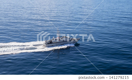 MESSINA, ITALY - 06 NOVEMBER, 2018: Speedboat Guardia di Finanza in the open sea with waves behind it MESSINA, ITALY - 06 NOVEMBER, 2018: Speedboat Guardia di Finanza in the open sea with waves behind it 141279215