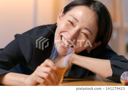 A woman in a suit getting drunk on beer. A woman in a suit getting drunk on beer. 141279423