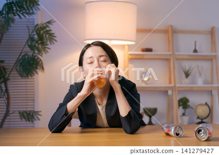 A woman in a suit getting drunk on beer. A woman in a suit getting drunk on beer. 141279427