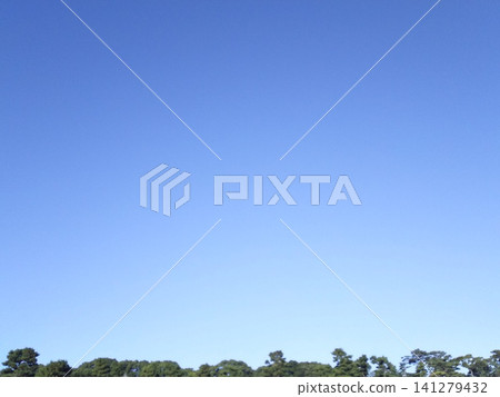 A background of a clear, cloudless blue sky with plenty of space for adding text. 141279432